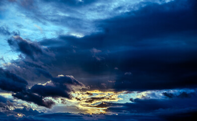 Dramatisch beleuchtete Wolkengebilde am Abendhimmel - obrazy, fototapety, plakaty