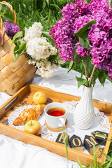 A picnic in the park with tea and lilacs
