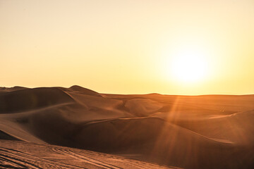 Fototapeta na wymiar sunset over the dunes in the desert in huacachina