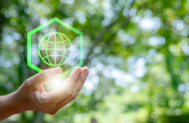 reuse, nature, plant, conceptual, sustainable, future, global, planet, responsibility, sustainability. A hand holding a globe with a green background. Concept of importance of taking of environment.