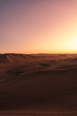 sunset over the dunes around huacachina in the Peruvian desert