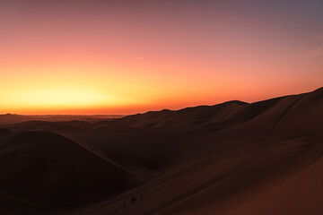 Fototapeta na wymiar sunset over the dunes around huacachina in the Peruvian desert