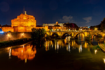 Castle of the Holy Angel (Castel Sant'Angelo) and St. Angel bridge over Tiber river at night, Rome,...