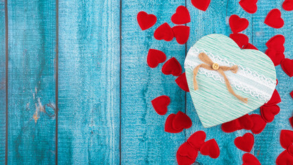 Valentine's Day concept banner with handmade gift box, and a lot of hearts on a blue wooden...