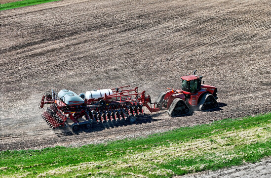 Spring Grove, WI - USA -  April 15, 2024, Case 500 Quadtrac tractorpulling a folded Case 2160 32 row planter