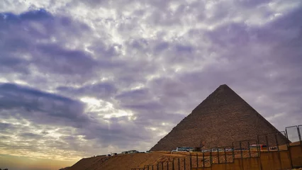 Foto op Canvas The Great Pyramid of Khufu sits high on the Giza plateau seen here on a cloudy morning before the arrival of visitors  © InnerPeace