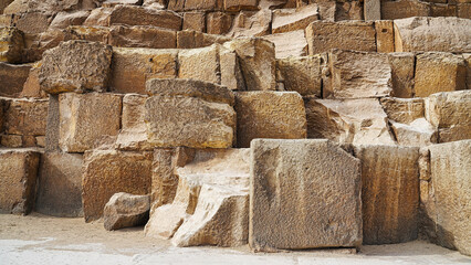 Close up of the Gigantic base rocks of the Great Pyramid of Khufu on Giza plateau made of tura...