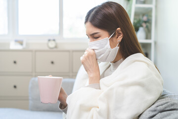 Sick, hurt or pain asian young woman, girl sore throat with glass, mug of warm water, headache have...