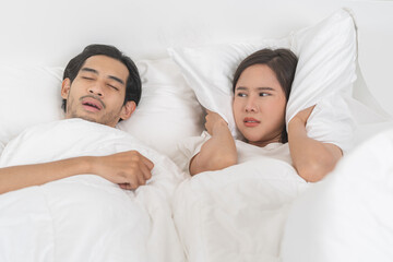 Snoring couple health asian man snore and sleeping at home while woman insomnia annoyed, bad noise...