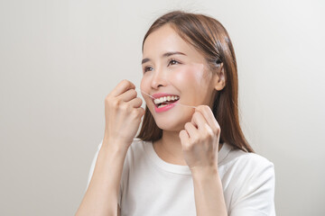 Flossing teeth, dental care hygiene concept, asian young woman flossing teeth with dental floss,...