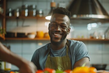 A smiling male chef enjoys his time in the kitchen, illustrating passion and expertise in cooking