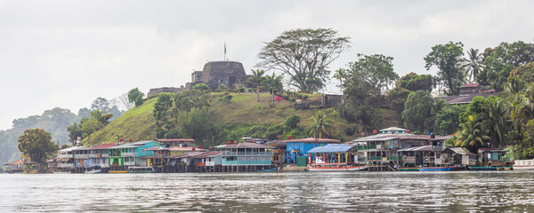 Scenic view of colorful houses and fortress of El Castillo village along the San Juan river in Nicaragua