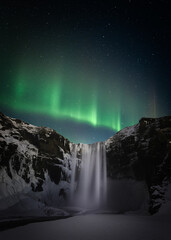 aurora borealis sbove waterfall
