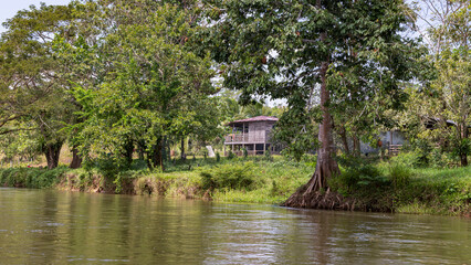 Scenic view of houses between trees along San Juan river also known as El Desaguadero at the border of Costa Rica and Nicaragua