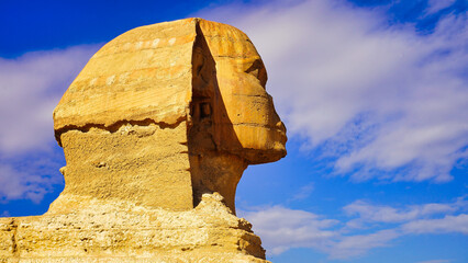 Close up view of the face of the Great Sphinx of Giza,said to resemble Pharaoh Khafre with its damaged nose on a bright sunny day on the Giza plateau 