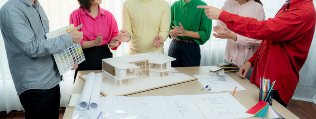 Professional interior designer team clapping hand to celebrate their successful project while...