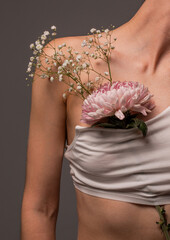 Flowers on a woman's collarbone. Women's health concept. Youth and beauty. Body care. Natural cosmetics for skin