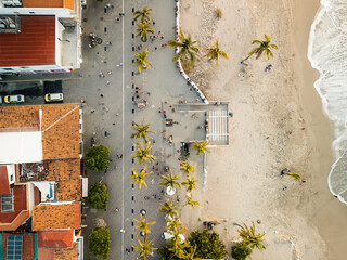 People walking on boardwalk seen from top down aerial view of el Malecon Puerto Vallarta Mexico.