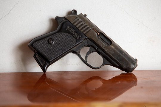 Air pistol Walther (caliber 8 mm ) very similar to Police Walther hndgun 9 mm  on wooden surface