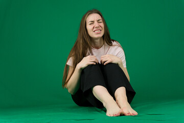 different emotions of a young girl on a green background chromakey beautiful facial features real...