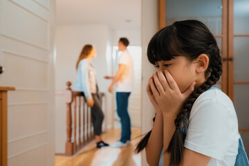 Stressed and unhappy young girl huddle in corner, cover her face while her parent arguing in background. Domestic violence at home and traumatic childhood develop to depression. Synchronos - obrazy, fototapety, plakaty