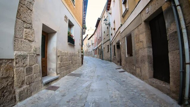 a cobbled street with traditional architecture in Castrojeriz, province of Burgos, Castile and Leon, Spain