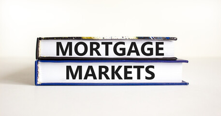 Mortgage markets symbol. Concept words Mortgage markets on beautiful books. Beautiful white table white background. Business mortgage markets concept. Copy space.