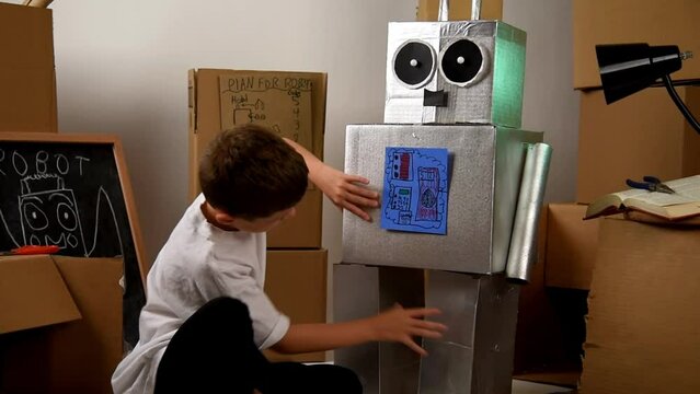 A science student is inventing a metal robot out of cardboard boxes with tools. Use it for an education or imagination concept.