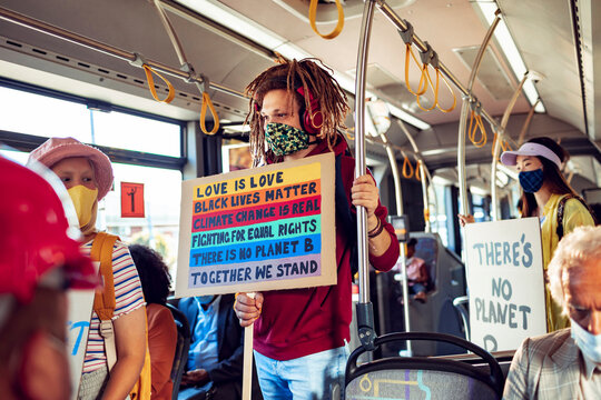 Activists with protest signs about climate change on a bus