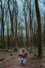 A little girl running in the woods