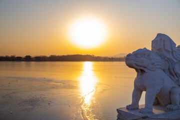 Chinese stone lions with sunset in the  Summer Palace, Beijing, China