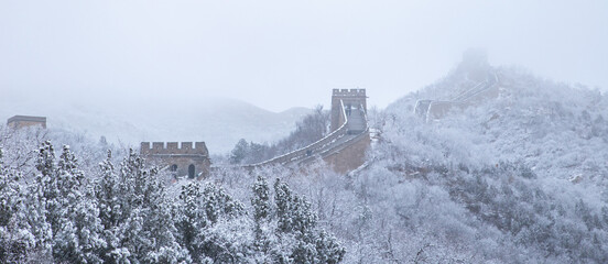 Panoramic view of the Badaling Great Wall with snow covered forest and fog in winter, Beijing, China