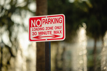 Horizontal NO Parking, loading zone only, 30 min max sign with arrows, red on white