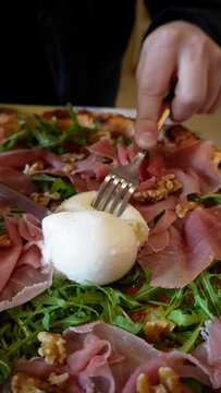 pizza mozzarella di bufala, arugula and prosciutto crudo, Italian traditional cuisine