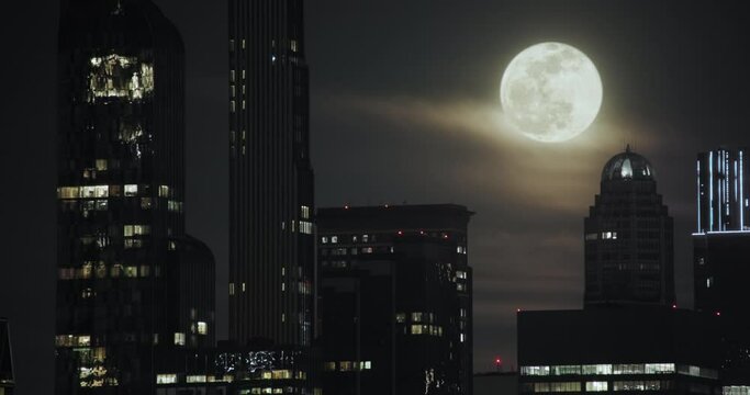 New York City Skyline with Full Moon Rising Over Buildings