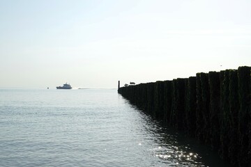 The north sea beach and coasline of the dutch village Westkapelle on summer day with high tide.