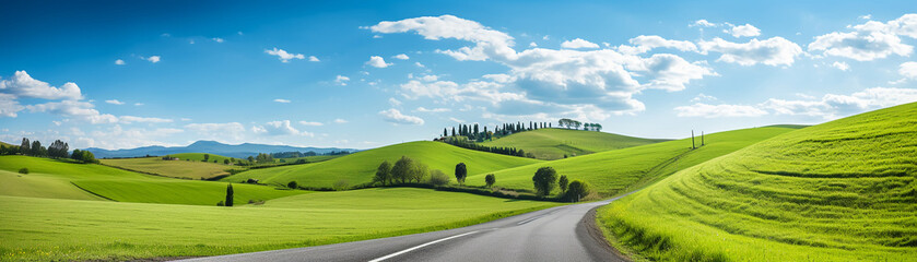 Fototapeta premium A scenic landscape with grassy hills stretching towards a clear blue sky
