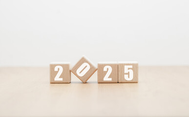 Wooden block with numbers 2025 on wooden table with white background, New Year 2025