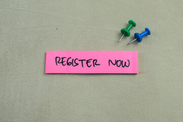 Concept of Register Now write on sticky notes isolated on Wooden Table.