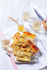 Puff pastry pie with cheese, pears, nuts and honey, served with champagne. - 790322878