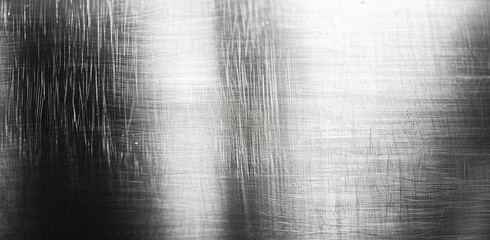Stainless steel surface with visible scratches and irregularities, detailed monochrome texture