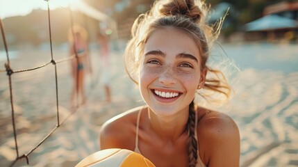 A happy beautiful woman holds a volleyball, laughing and looking at the camera