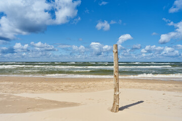 Wooden post on the sea beach. Baltic sea landscape - 790324427