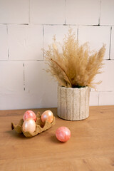 natural colored Easter eggs are lying on the kitchen table, preparation for Easter, an element of Easter decor, Spring easter composition