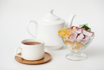 Sweet rahat lukum with a cup of tea on a white background