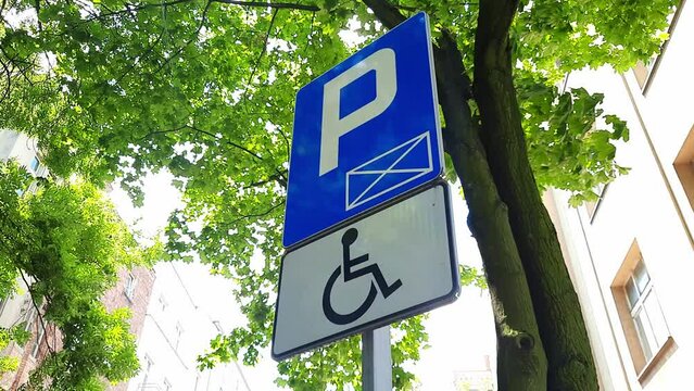 Parking only for disabled drivers. Road sign against background of tree. Concept of Accessible Parking and locations. Adapted spaces for people with disabilities. Inclusion.