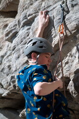 Male climber next to rope and quick draw