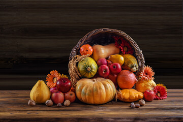 Thanksgiving day still life, background with empty copy space. Pumpkin harvest in wicker basket....