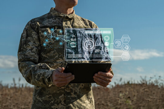 AI technology in the army. Warfare analytic operator checking coordination of the military team. Military commander with a digital tablet device with artificial intelligence operating troops outdoors