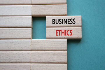 Business ethics symbol. Concept word Business ethics on wooden blocks. Beautiful grey green...
